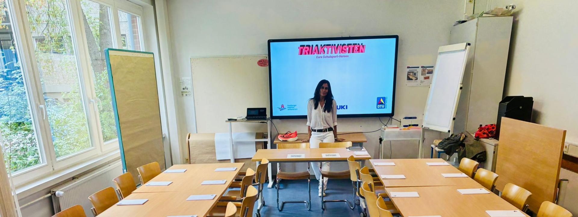TriAktivistin Loreto Cea bei der Lehrerfortbildung im Hamburger Institut für Lehrerbildung, im Hintergrund der Screen „TriAktivisten – Eure Schulsport-Heroes".